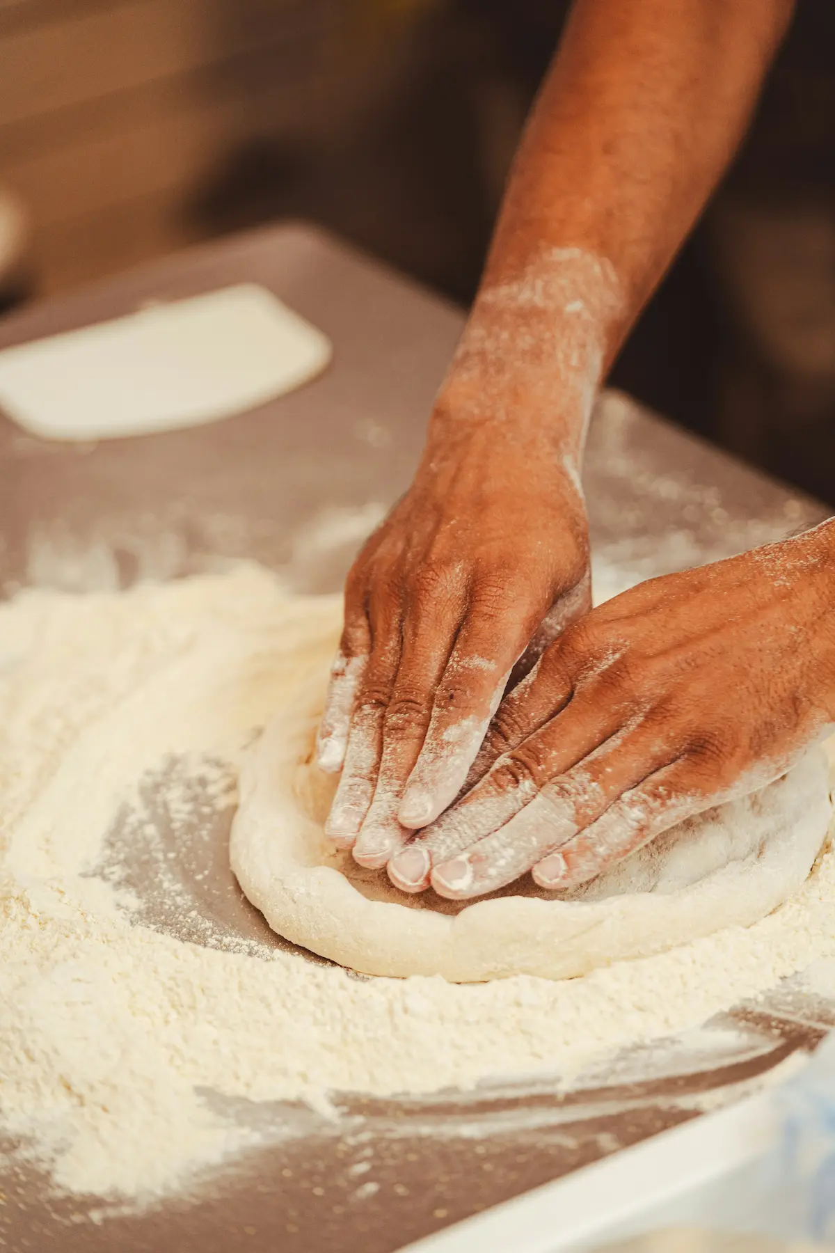 Pizza dough being kneaded